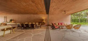 A modern, spacious living room with a unique terrazzo floor and comfortable seating arrangements.
