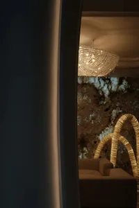 A luxurious living room featuring a large, sparkling crystal chandelier.