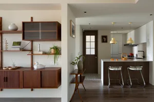 A modern kitchen with minimalist design and wooden features.