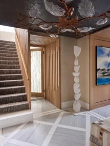 A modern interior design featuring a wooden staircase and a contemporary floor lamp.
