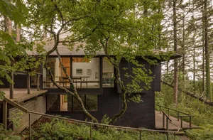 Modern residential architecture featuring wood, glass, and metal materials.