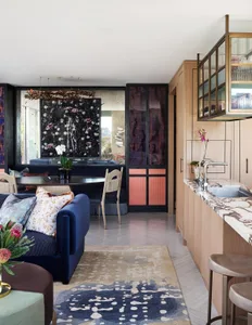 A modern interior design featuring a mix of materials such as wood, marble, and metal.