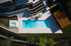 Modern residential pool area with concrete deck and steps