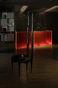 A sleek, modern black chair made of polished chrome with a glossy finish.