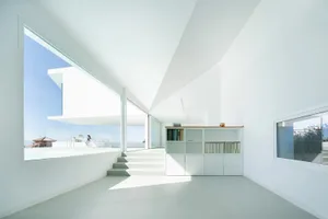 A clean, modern residential space featuring concrete and glass materials.