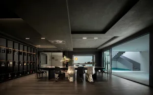 A modern residential dining area featuring concrete materials, with a minimalist design and a view of an external staircase a