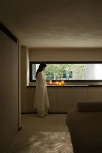 A modern residential interior with textured cloth flooring and minimalistic decor.