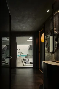 A modern living space featuring concrete tiles, minimalistic decor, and a serene atmosphere.