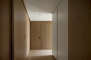 A modern hallway with wooden walls and flooring.