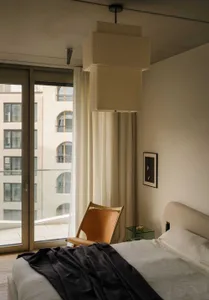 Minimalist bedroom with neutral tones and minimalist decor.