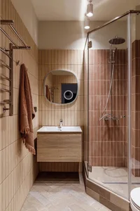 A modern bathroom featuring wooden fixtures and ceramic tiles.
