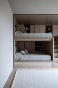 Modern minimalist bunk beds with grey bedding.