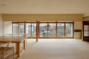A modern living room with wooden furniture and light-colored flooring.
