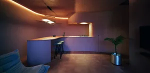 A modern residential kitchen with concrete surfaces and minimalist design.