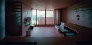 A modern living room with concrete flooring and walls, featuring a lounge area and a bar counter.