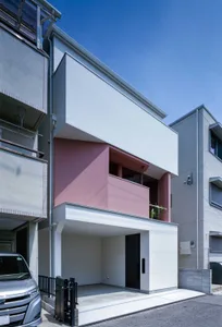 Modern residential exterior featuring concrete and glass materials.