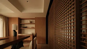 A traditional home office featuring wooden shelves and furniture.