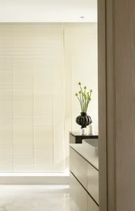 Modern minimalist bathroom features ceramic tiles and glass window blinds.