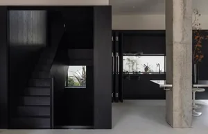 A modern kitchen with dark wood cabinets and a large window.