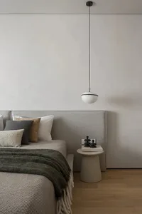 Bedroom with minimalist design featuring textured fabrics and wooden elements.