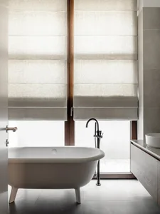 A minimalist bathroom featuring tiled flooring and white fixtures.
