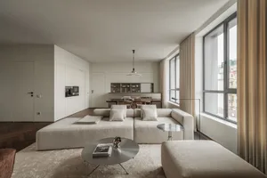 A modern living room with a sofa, coffee table, and minimalist decor.