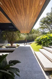 A modern landscape featuring a concrete walkway surrounded by greenery.