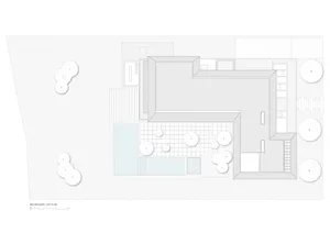 Top-down view of a site plan with buildings, pathways, and areas marked.