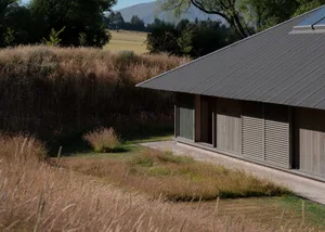 Modern exterior of a house made of metal, glass, and concrete materials.