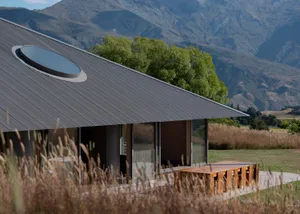 A modern residential building featuring a roof with metal roofing material.