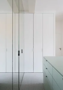 A modern white closet with a minimalist design.