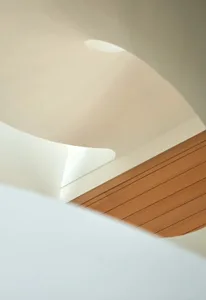 Modern staircase featuring white timber steps and railings in a minimalist interior design.