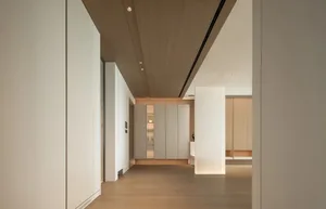 Modern minimalist living room with wooden flooring and furniture.