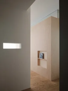Modern minimalist interior design showcasing a feature wall constructed from light-colored wood.