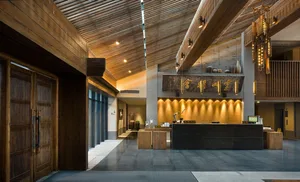 A hotel reception lobby featuring wooden architectural elements and design.