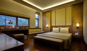 A contemporary bedroom featuring wooden furniture and modern decor.