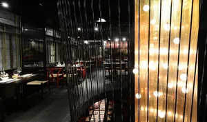 Modern restaurant interior featuring metallic lights curtain