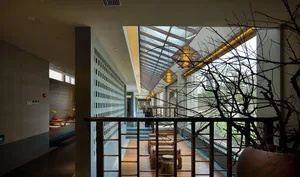A modern restaurant bar with glass walls and sleek interior design.