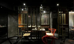 Modern restaurant interior with wooden seating and metal accents