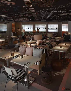 An industrial-style restaurant interior with metal tables, wooden chairs, glass windows, fabric seating, and a chalkboard cei