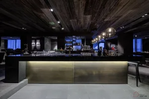 A modern bar with wooden elements and a sleek, minimalist design.