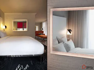 Modern bedroom with white brick wall, white bedding, and wall-mounted lamp