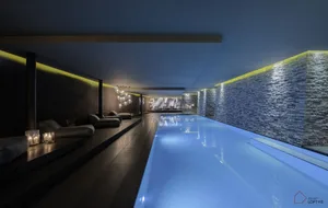 Modern interior design featuring sleek, minimalist living room with concrete walls and glass elements.