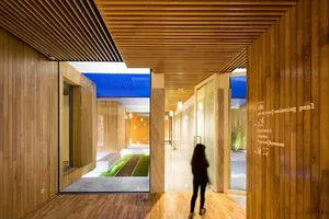 A modern lobby entrance featuring wood and glass materials