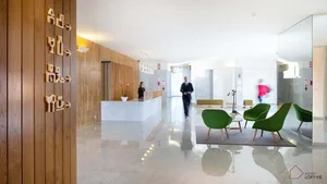 A modern office space with concrete walls and glass elements.