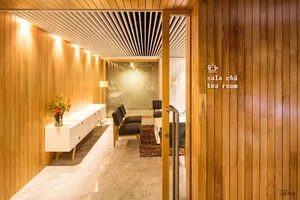 Modern tea room with wooden walls and a tea table.