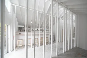 Minimalist interior design featuring a loft bar with white steel and wood finishes
