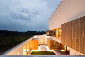 Modern residential exterior with concrete and glass materials.
