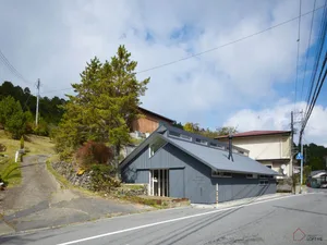 A modern residential building with metal siding and a unique architectural design.