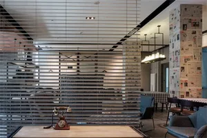 Metal counter with a vintage telephone on it in an industrial-themed cafe setting.